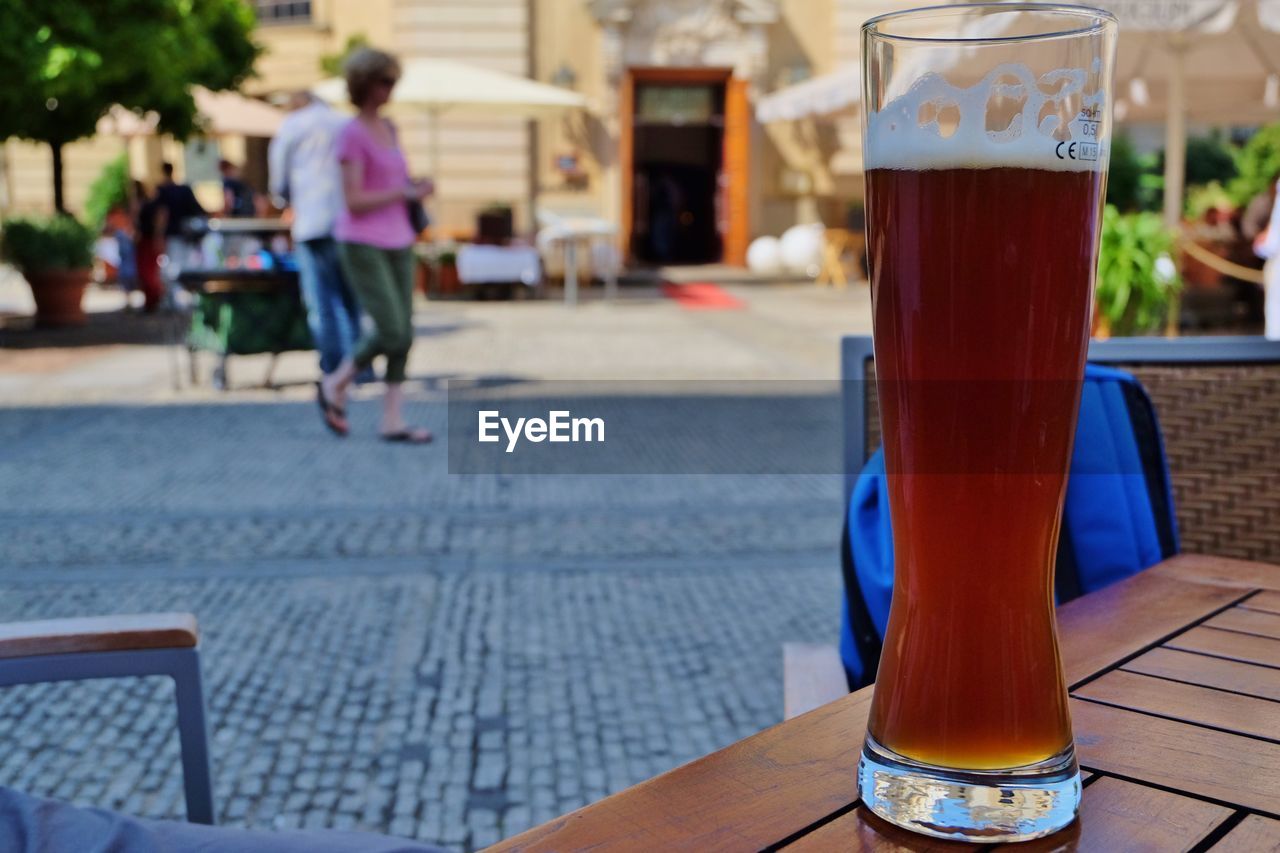 Beer glass on table at cafe