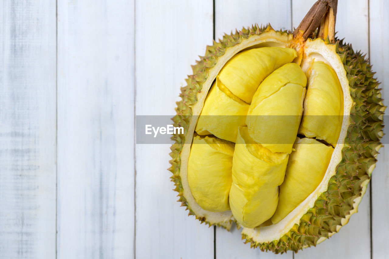 Top view of durian fruit. ripe monthong durian on white wood background, king of fruit 