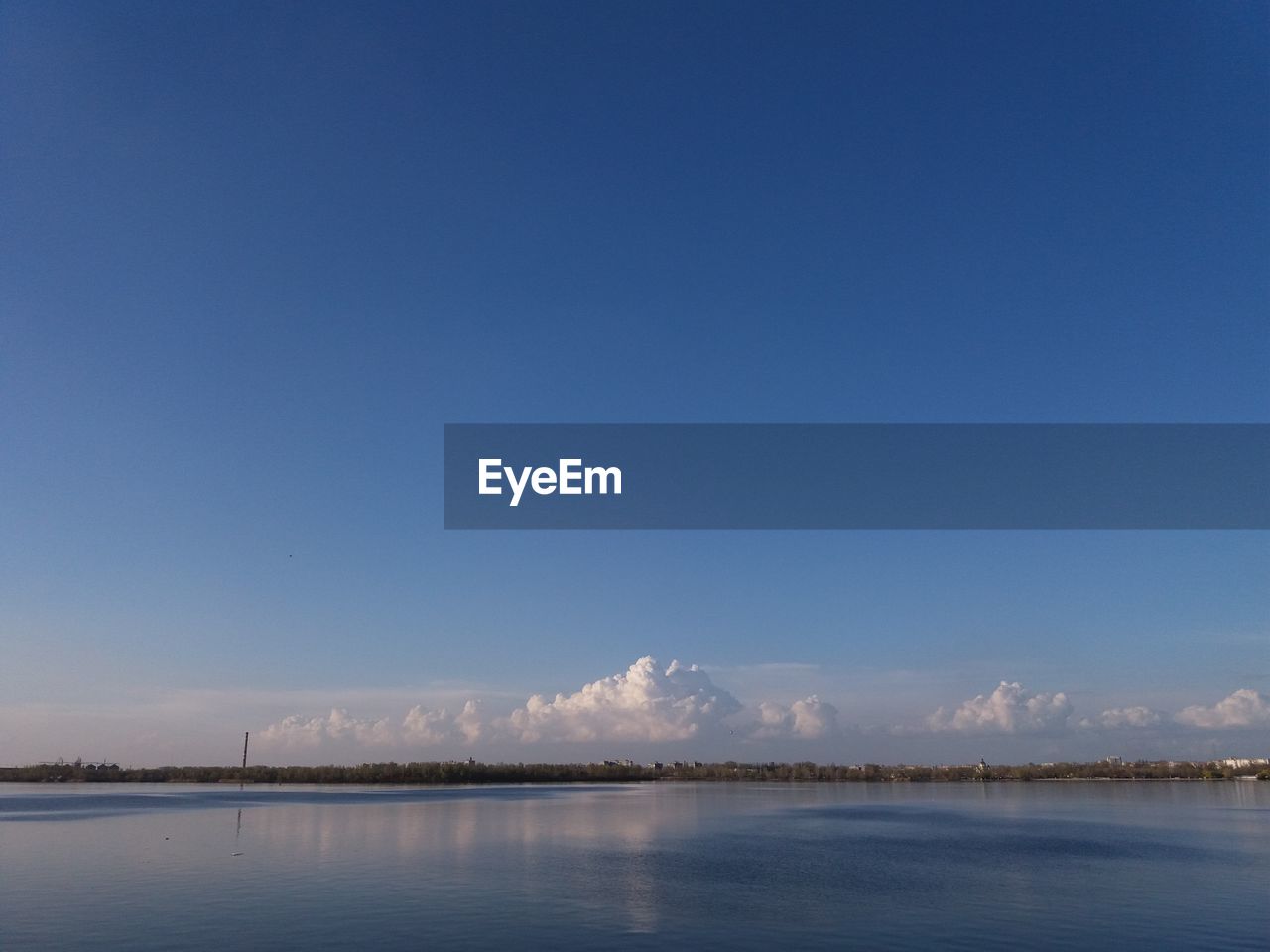 Scenic view of lake against blue sky