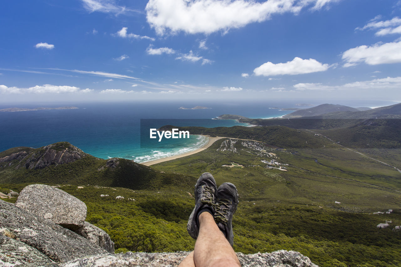 Scenic view of sea and mountains against sky