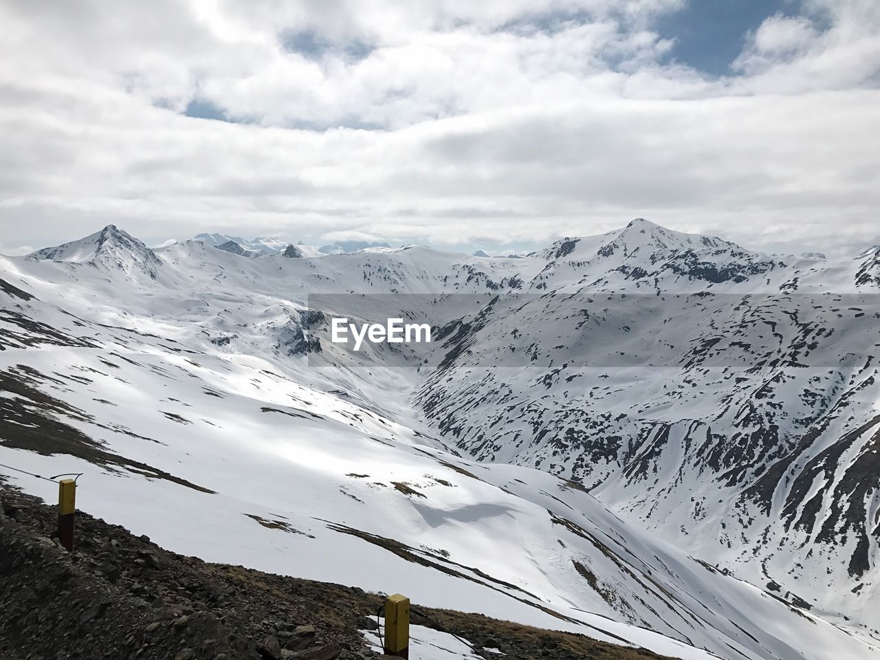 Scenic view of snowcapped mountain against cloudy sky