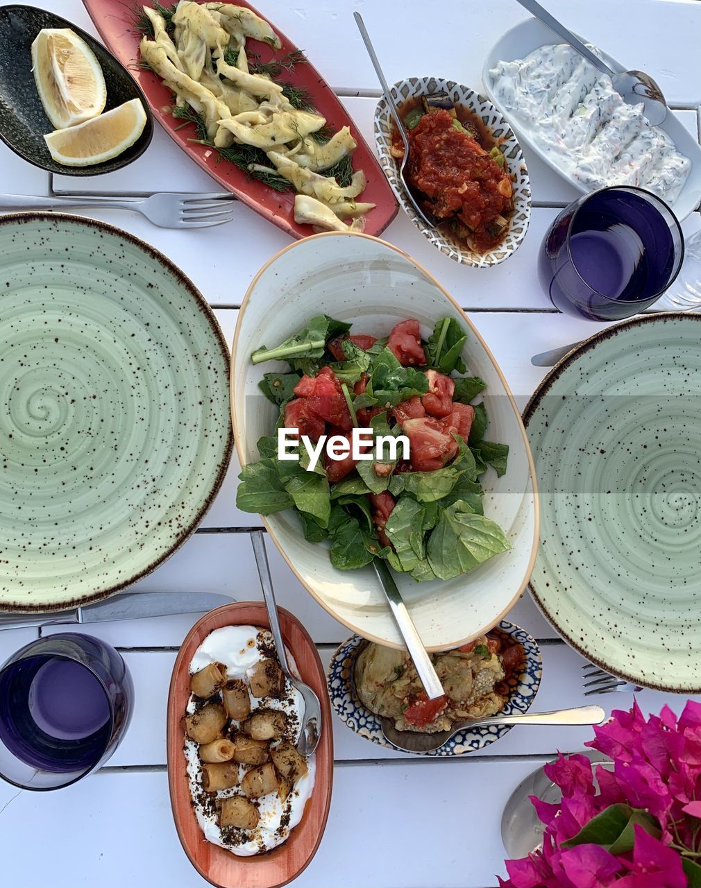 Mediterranean cuisine. appetizers and salad in seaside restaurant. colourful meze on ceramic plates