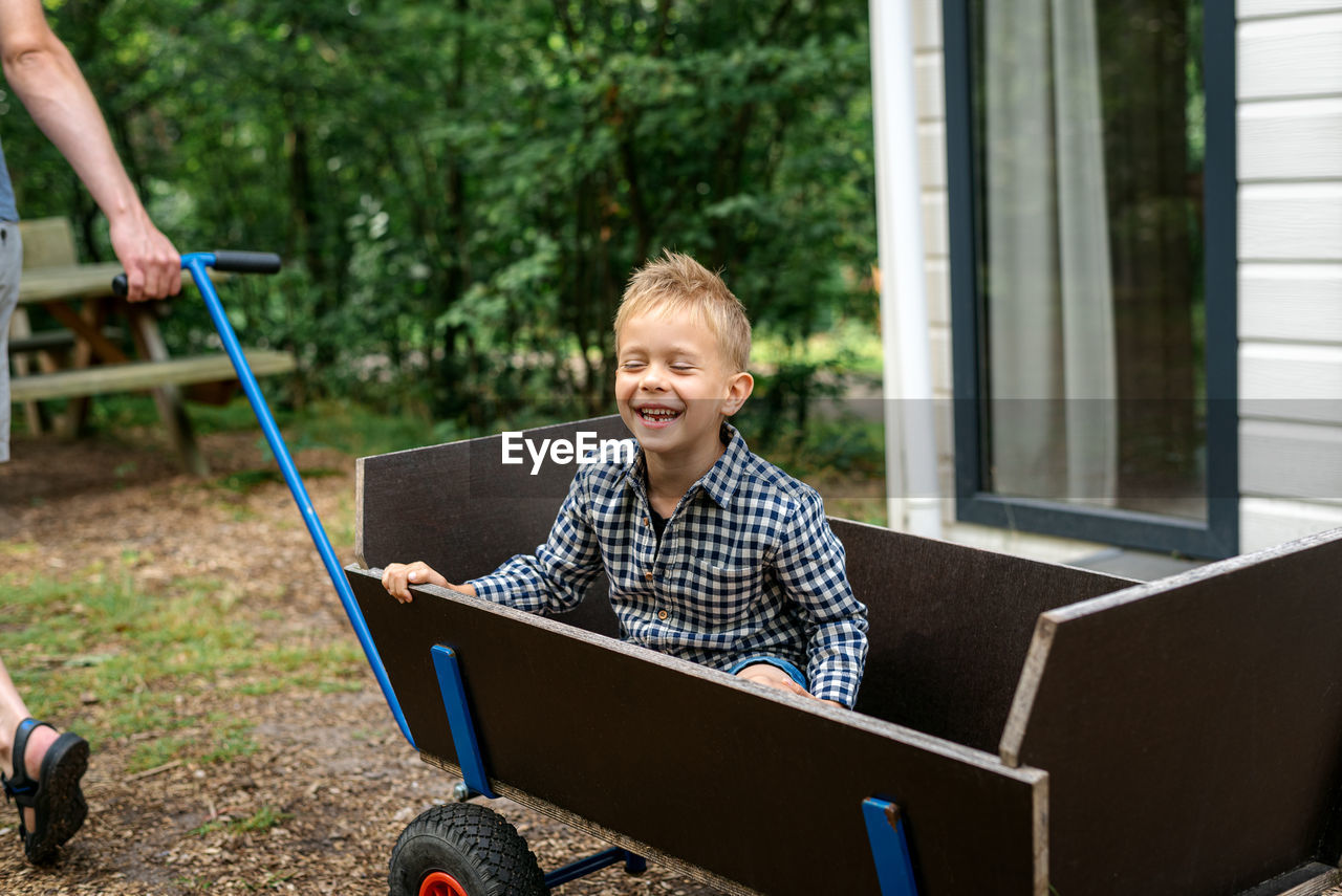 Smiling boy sitting n cart