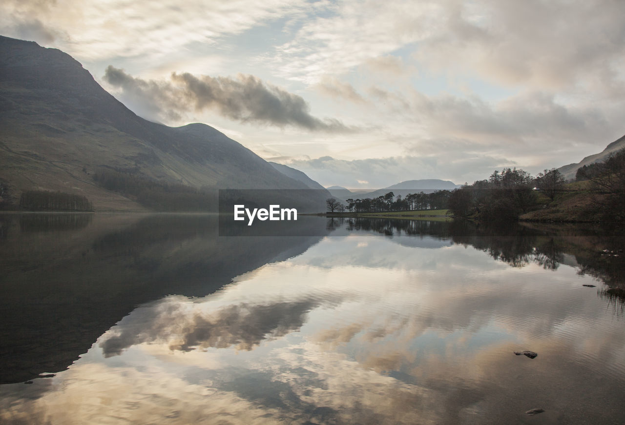 Scenic view of lake and mountains against sky