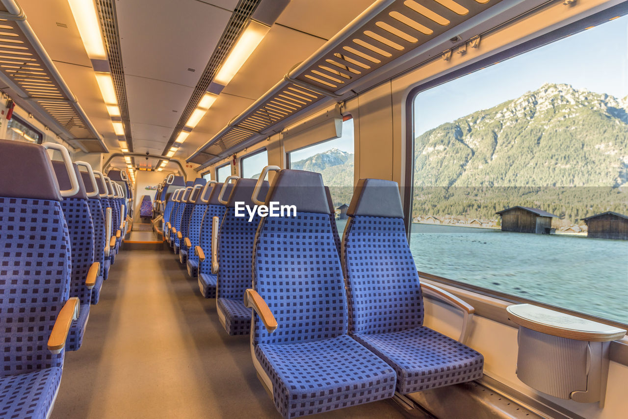 Interior of empty train against river