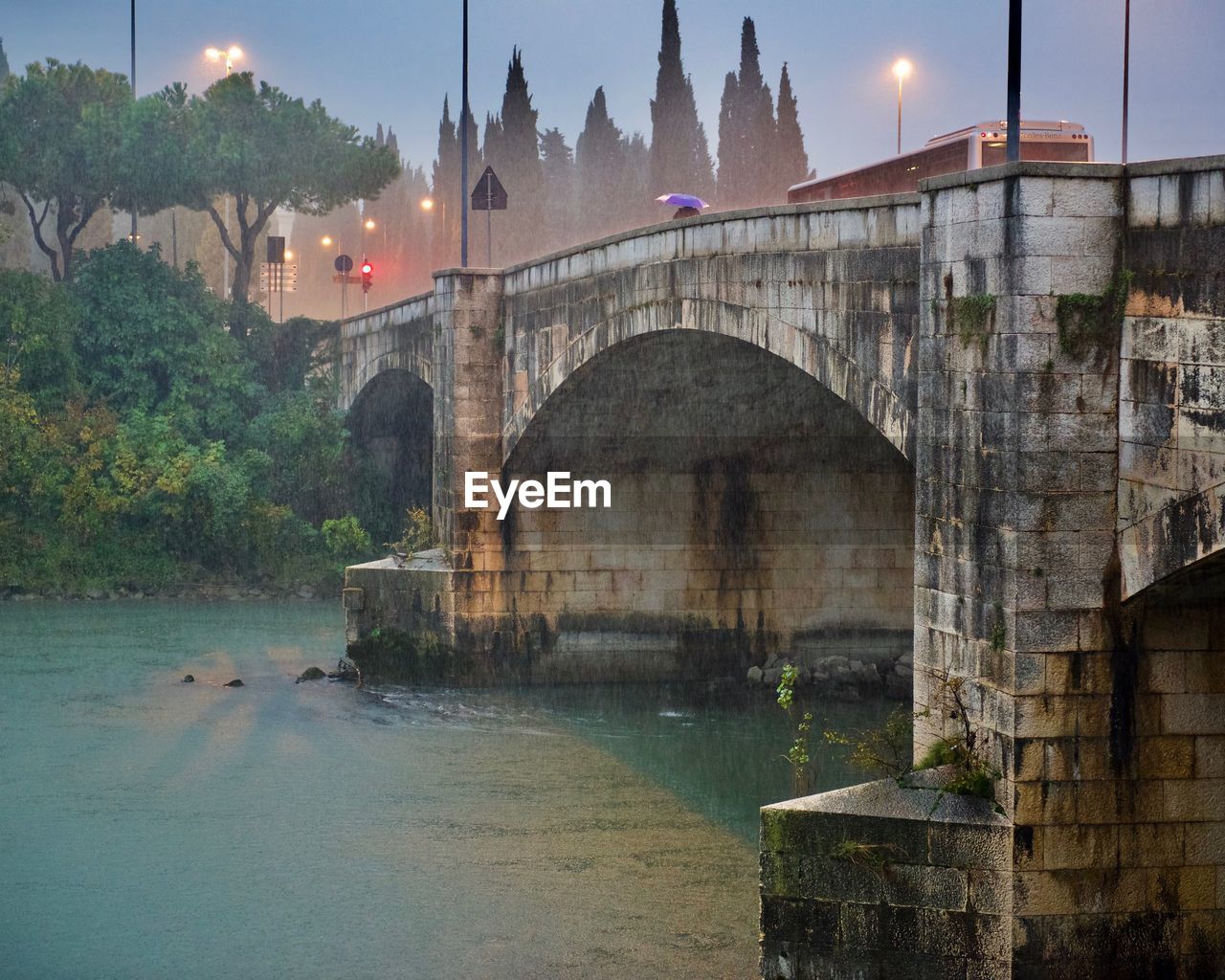 Old arch bridge over river