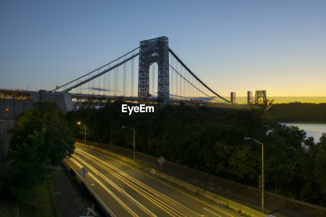 Suspension bridge against sky during sunset