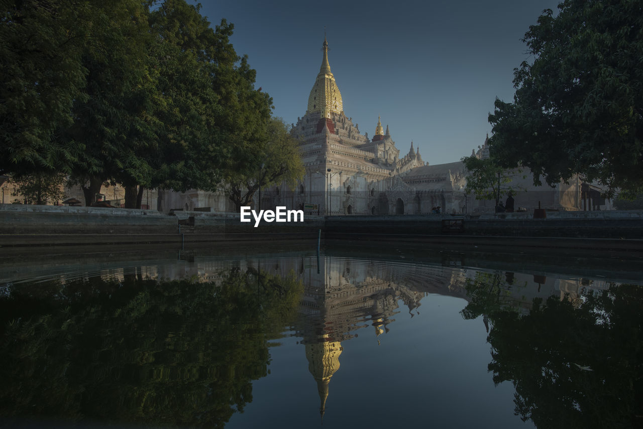 Reflection of trees and buildings in lake