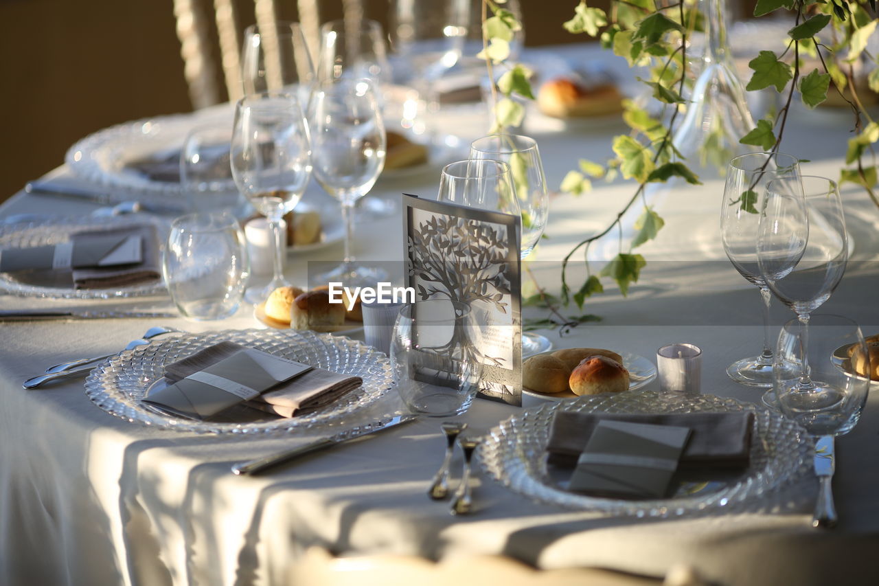 Table set for the wedding reception. plate cutlery and napkins, with flowers in the centerpiece