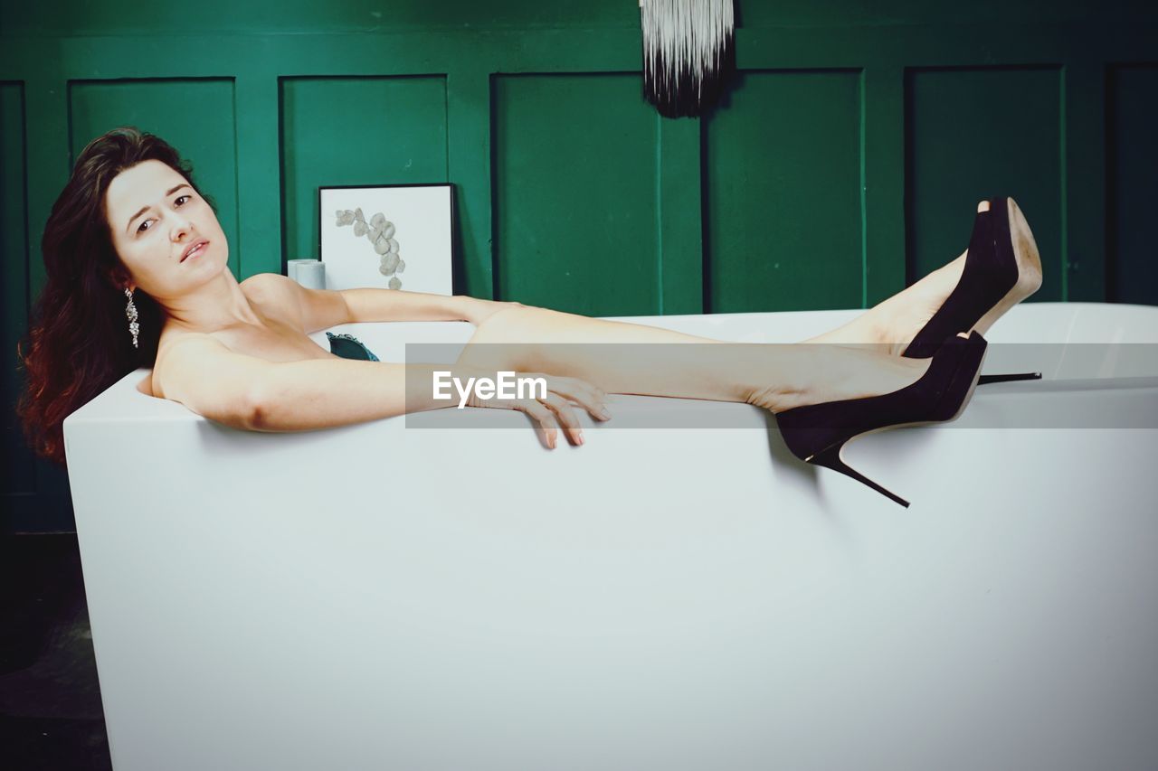 Portrait of woman lying in bathtub