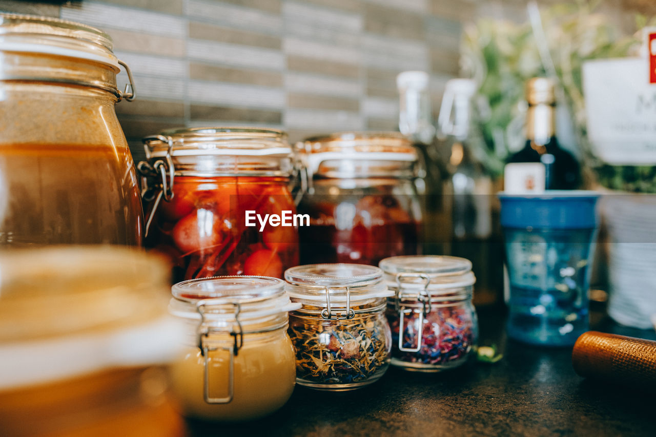 Close-up of various herbs in jar on table