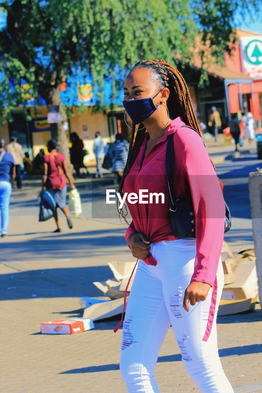 Woman with sunglasses on street in city