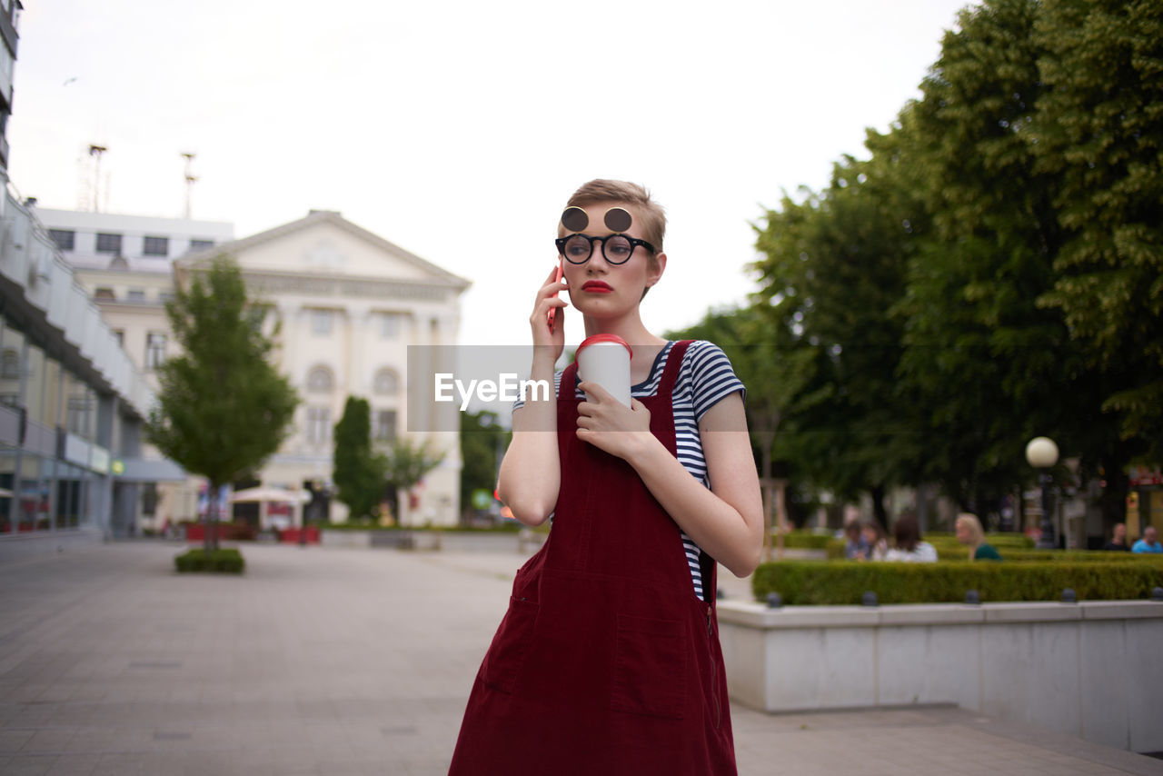 Young woman talking on phone while standing outdoors