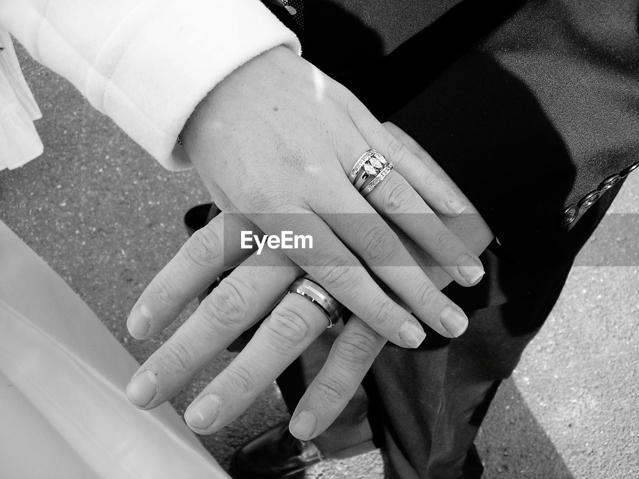 Cropped image of man and woman showing wedding rings