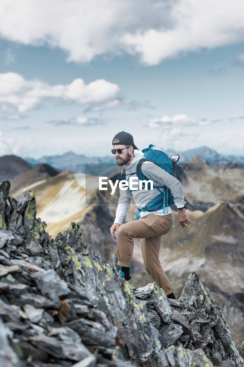 Man walks in the mountain wilderness in the italian alps