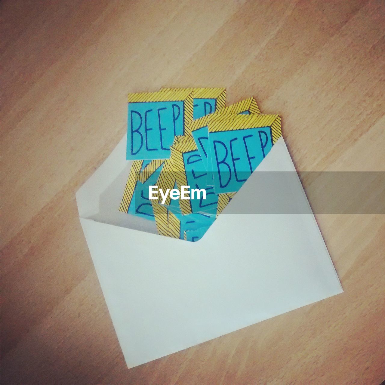 High angle view of beep text on paper in envelope