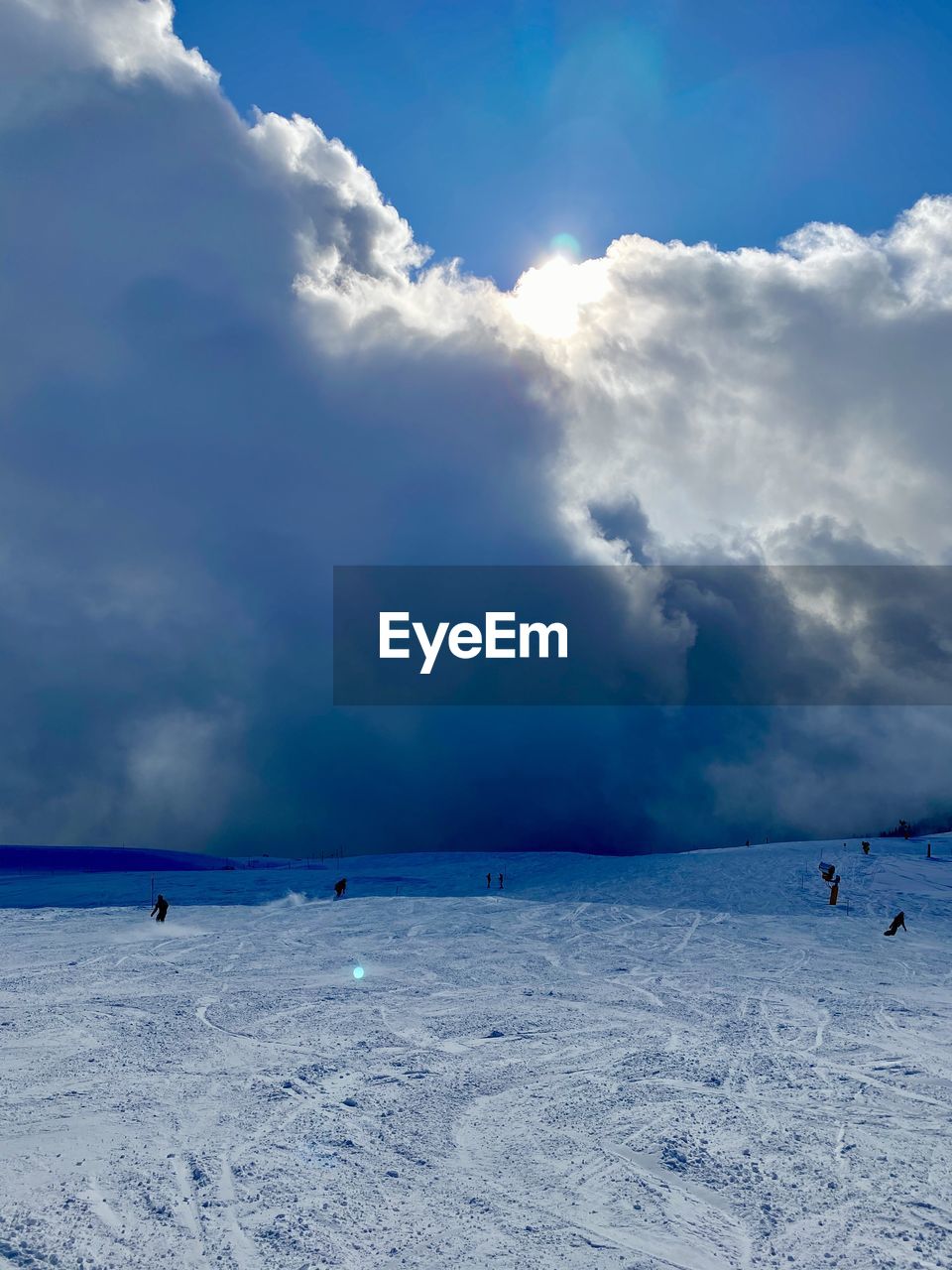 Scenic view of snow covered land against cloudy sky