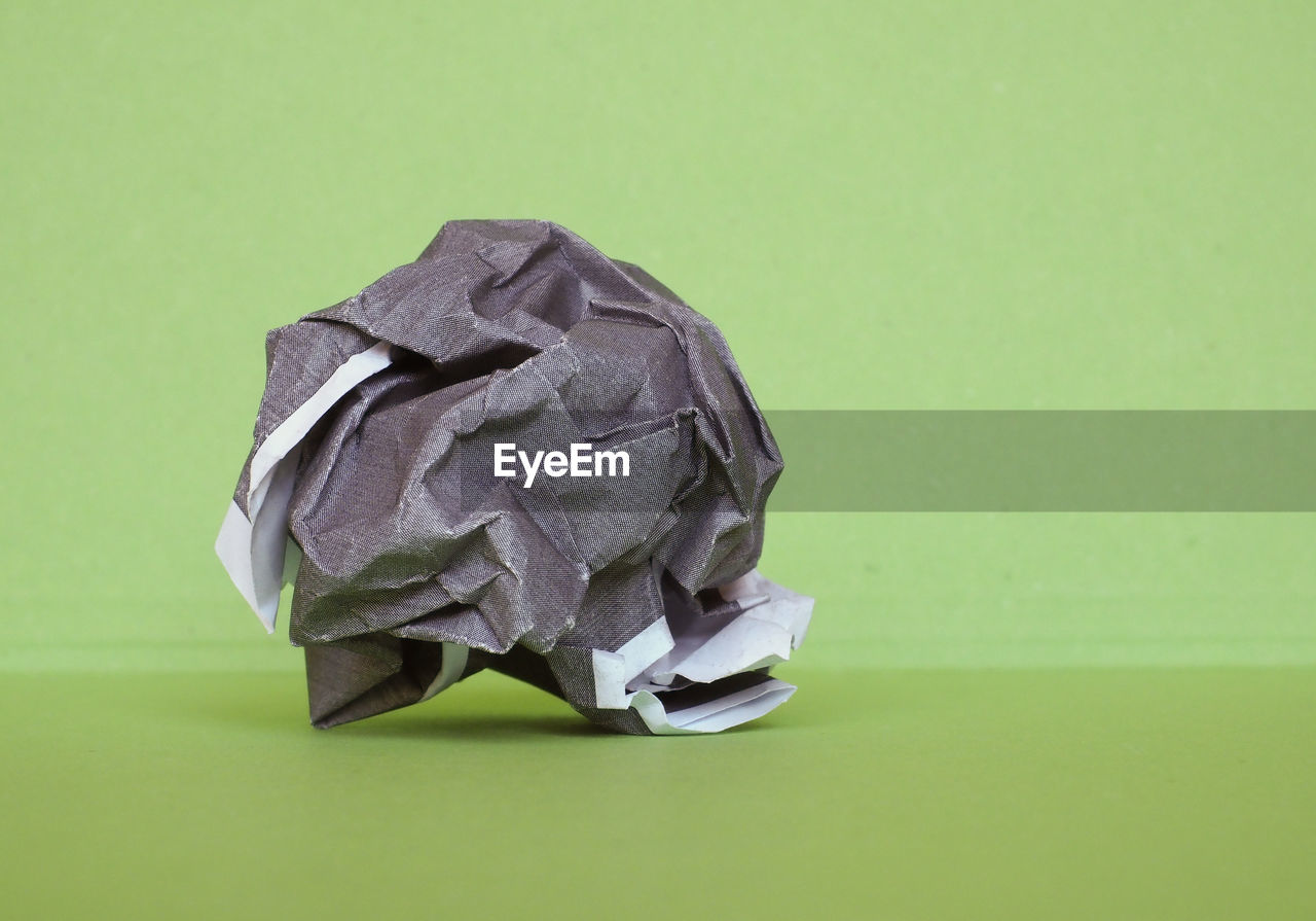 green background, crumpled, colored background, crumpled paper, art, origami, paper, studio shot, green, origami paper, no people, crumpled paper ball, indoors, copy space, garbage, business, recycling