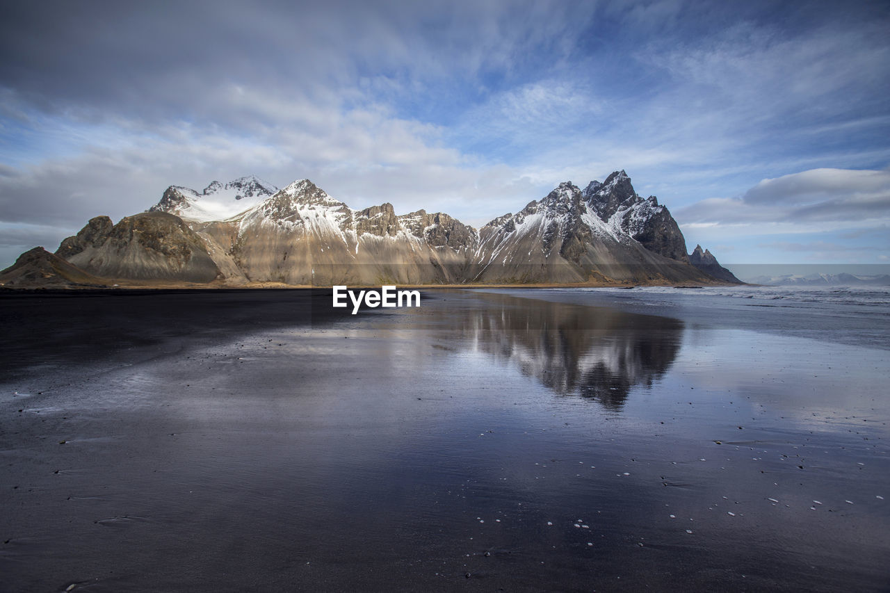 Scenic view of lake against cloudy sky