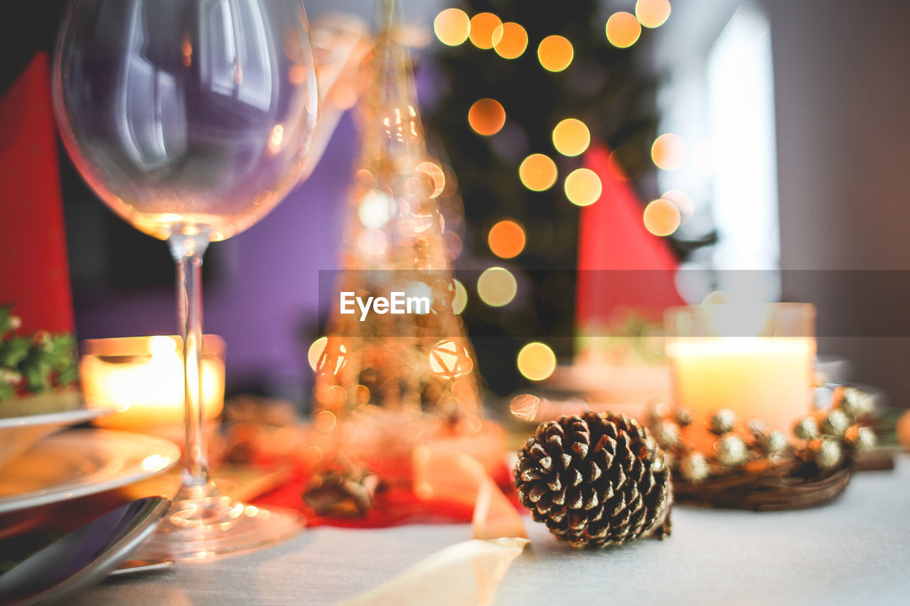 Objects on table against christmas lights