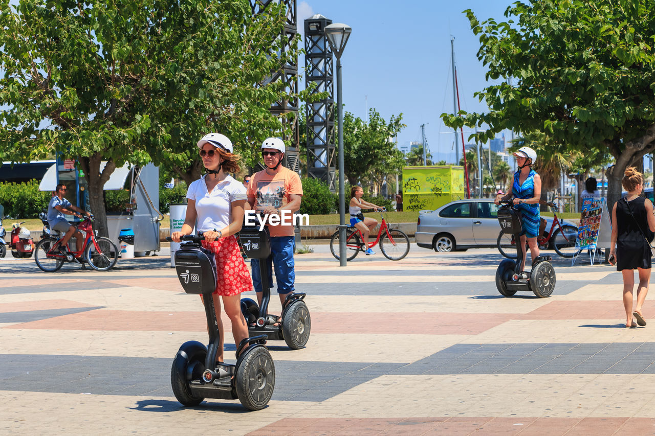 PEOPLE RIDING BICYCLES ON ROAD