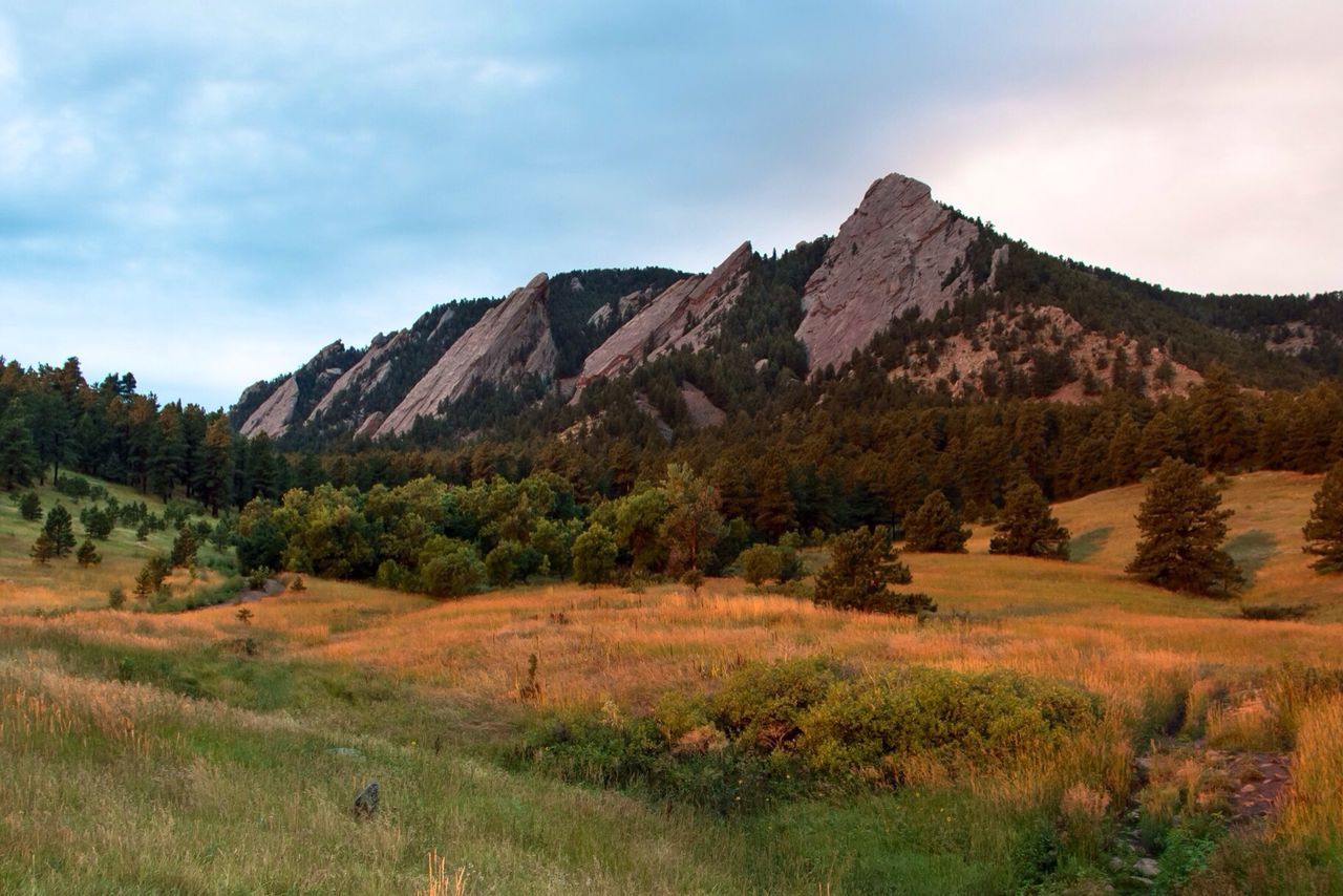 Scenic view of mountains against cloudy sky