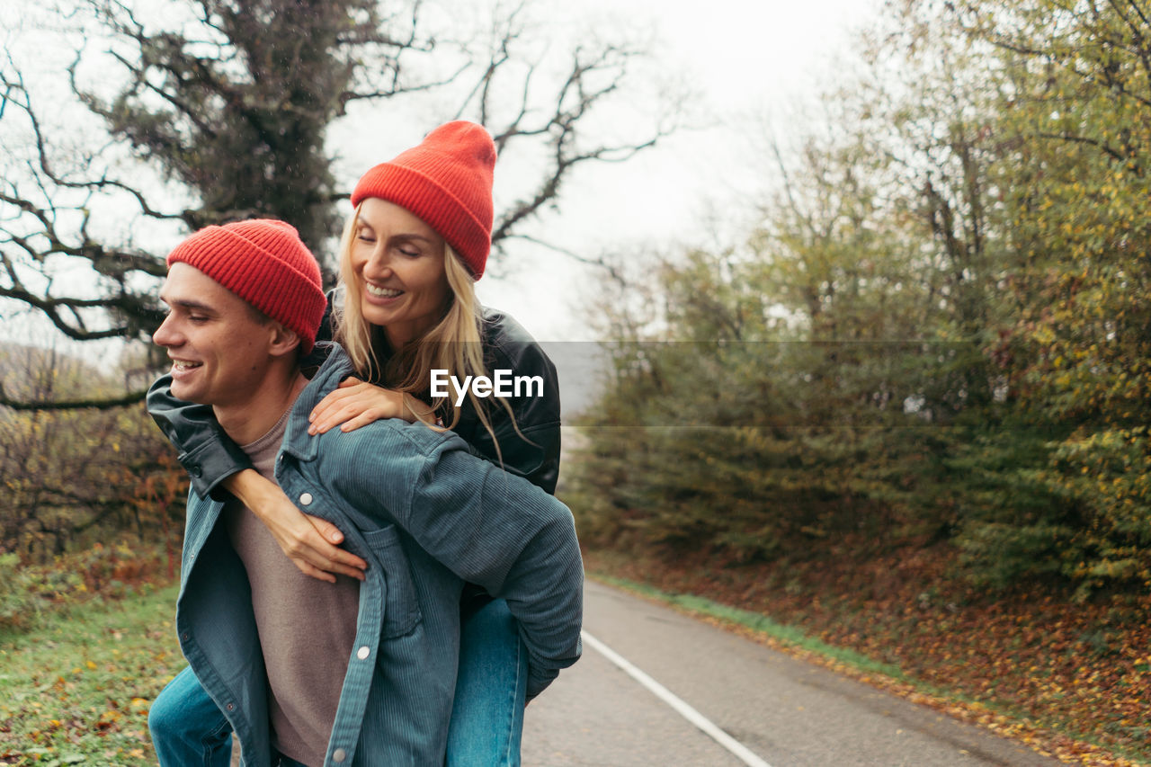 A young couple in love is fooling around on a walk. valentine's day concept.