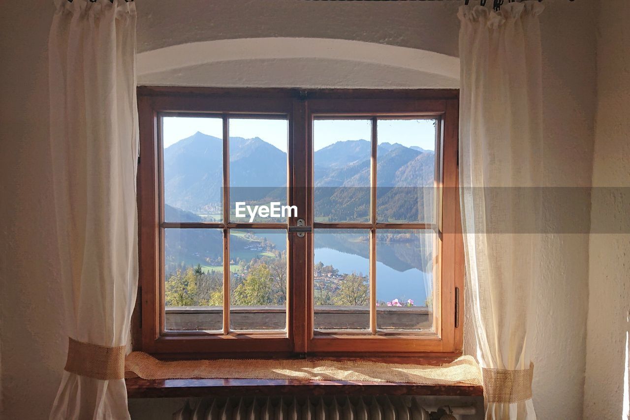 WINDOW OF HOUSE AND MOUNTAIN