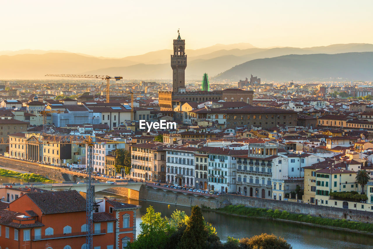 View of florence in italy at sunset by the arno river