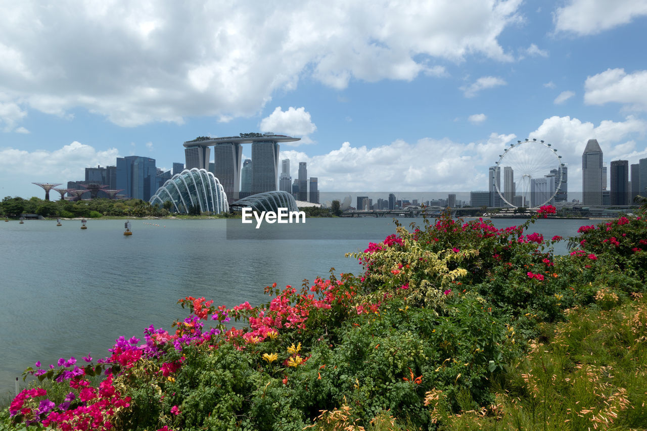 SCENIC VIEW OF LAKE AND BUILDINGS AGAINST SKY