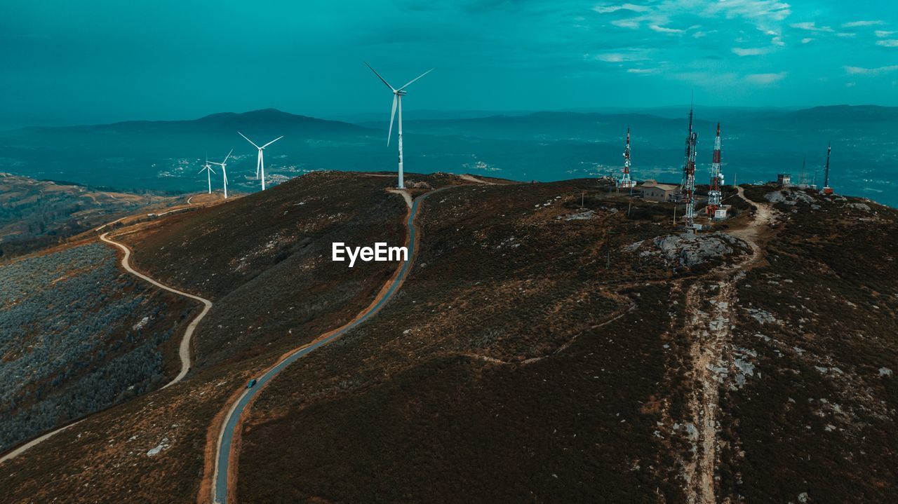 Panoramic view of wind turbines on land
