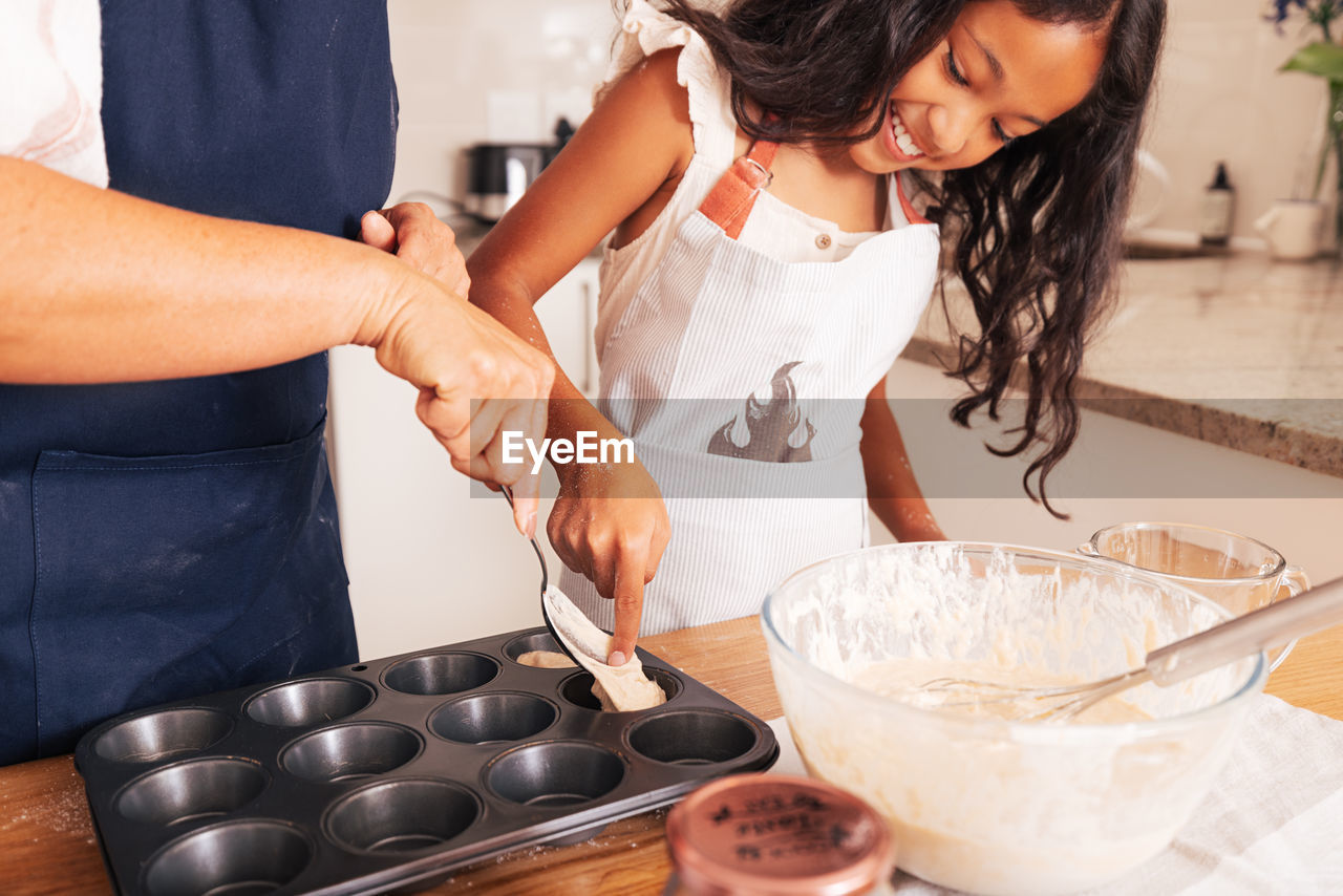 midsection of woman preparing food at home