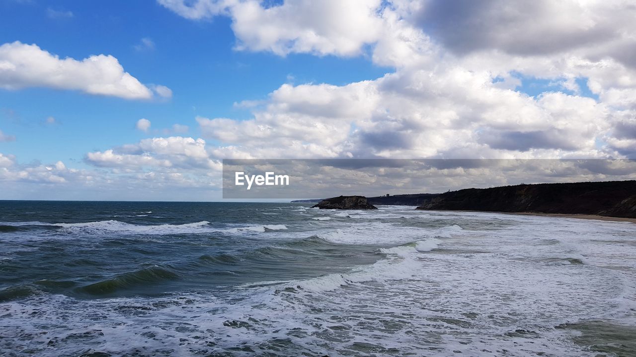 Scenic view of beach and cloudy sky