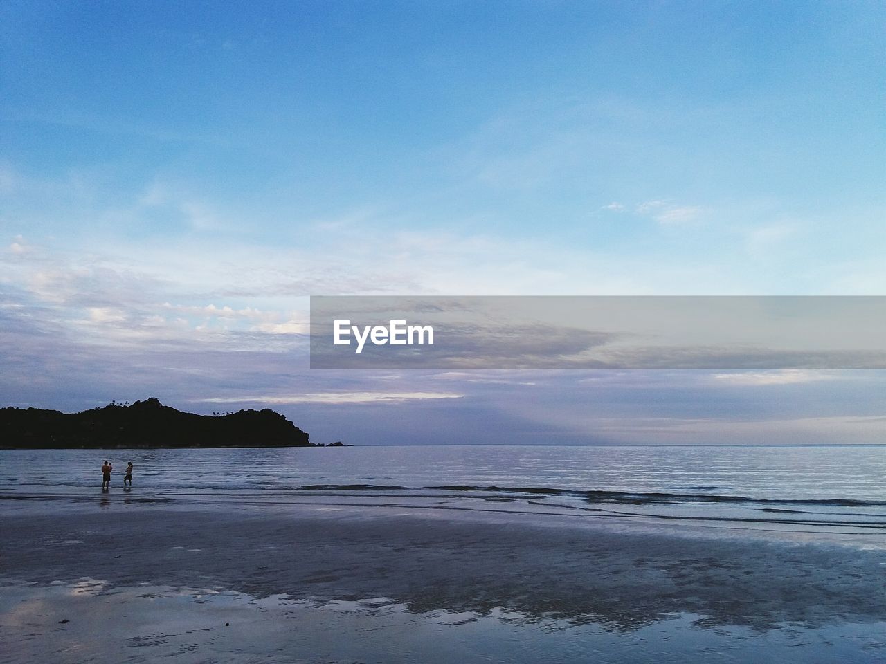 Scenic view of sea against blue sky