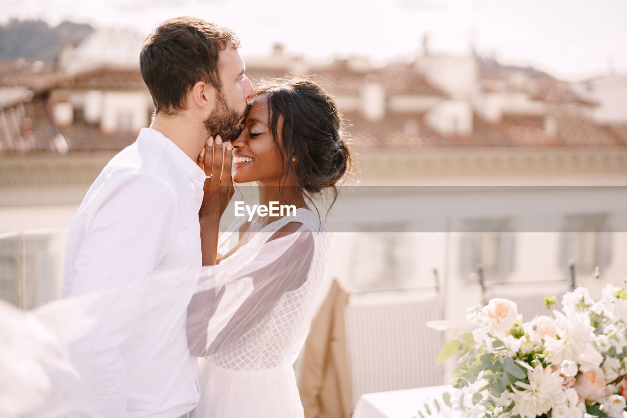 Young couple kissing on flower