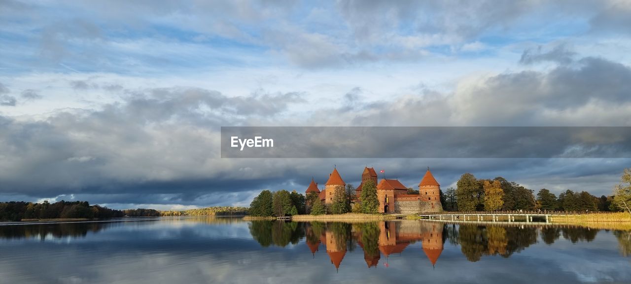 scenic view of lake by trees against sky