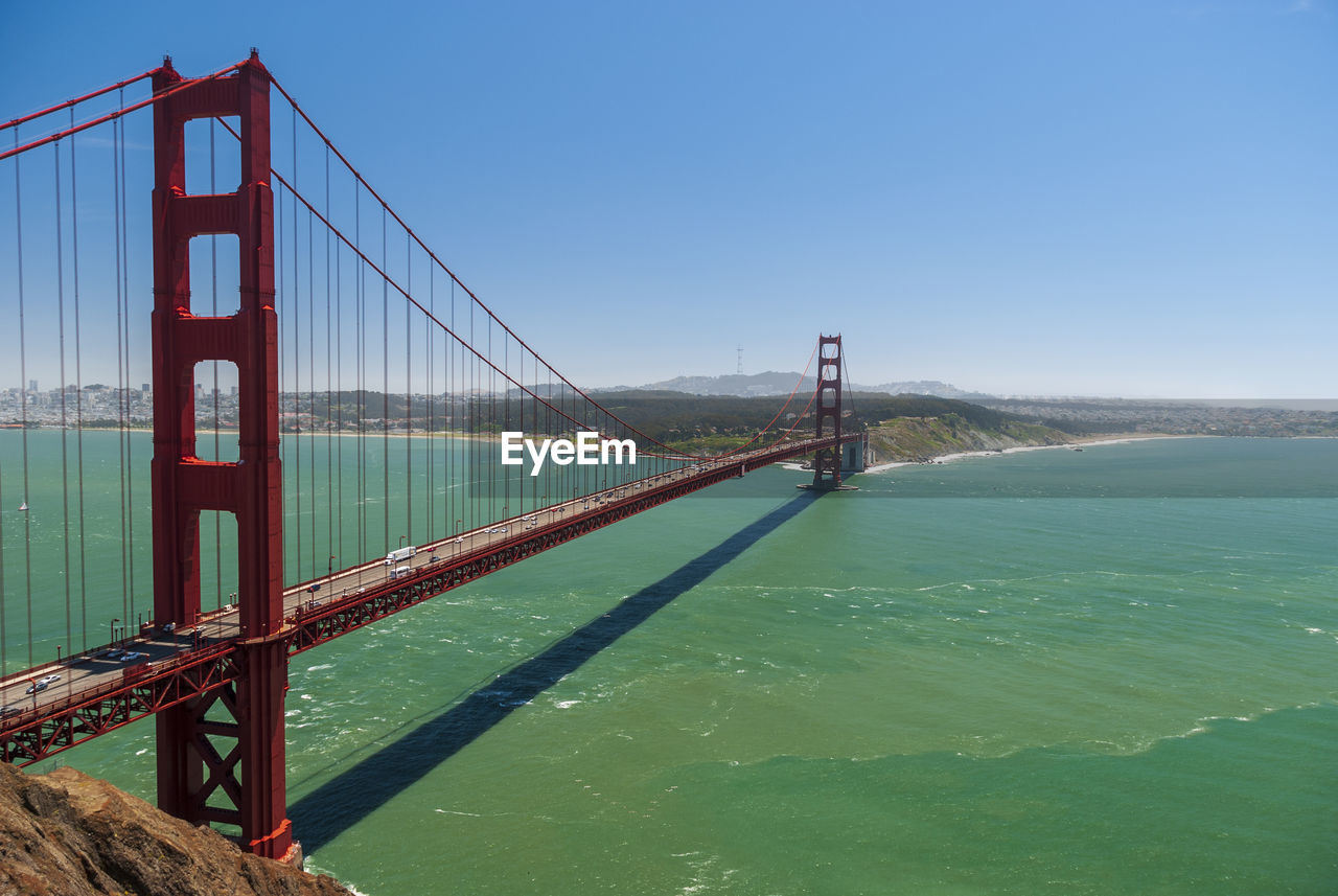 View of suspension bridge over sea against sky