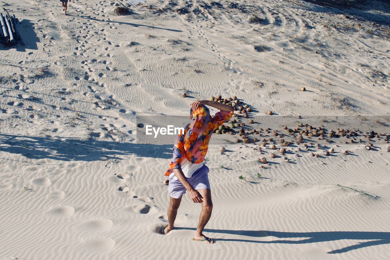 Full length of man walking on sand