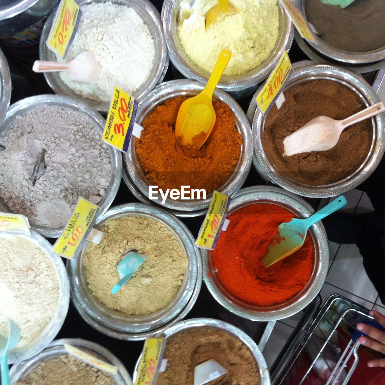 Directly above view of spices with price tags at market stall
