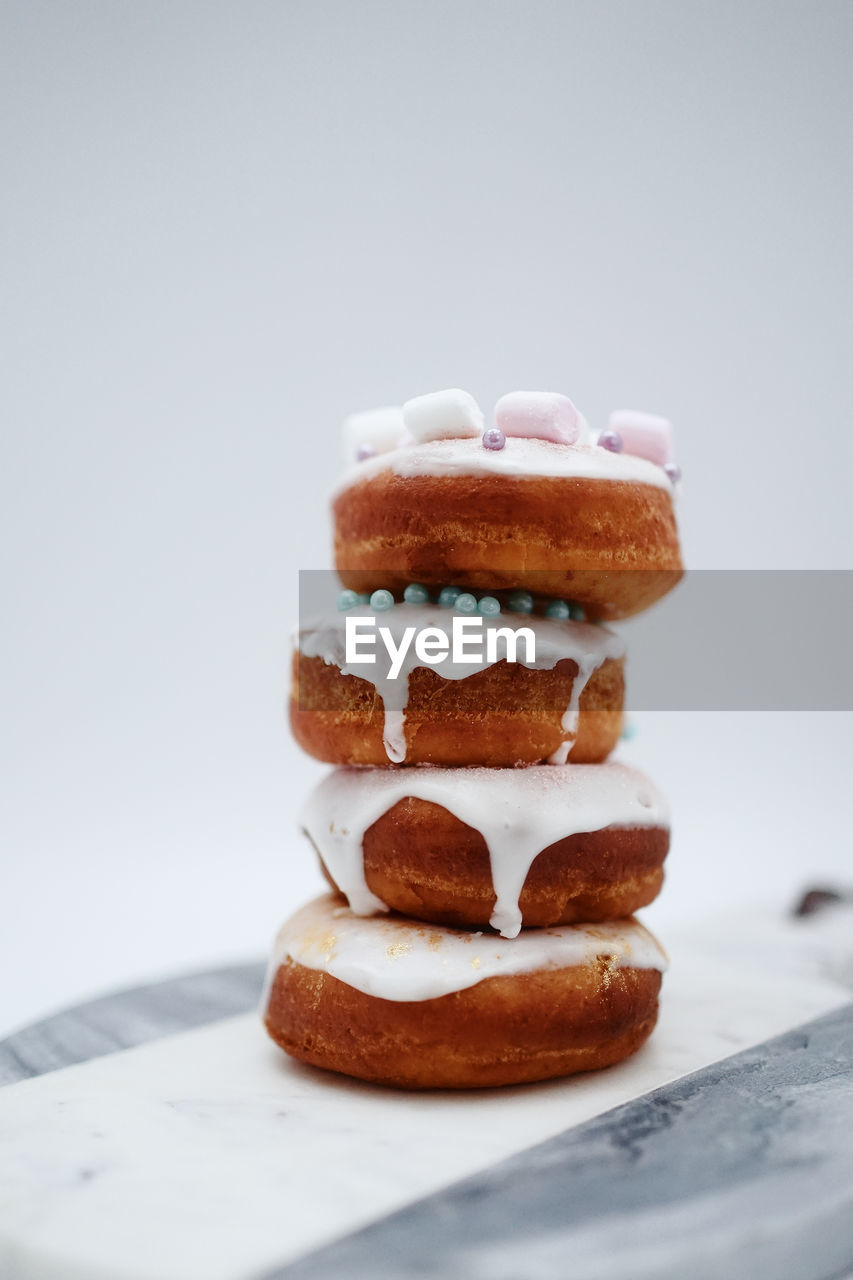 Close-up of cake on table against white background