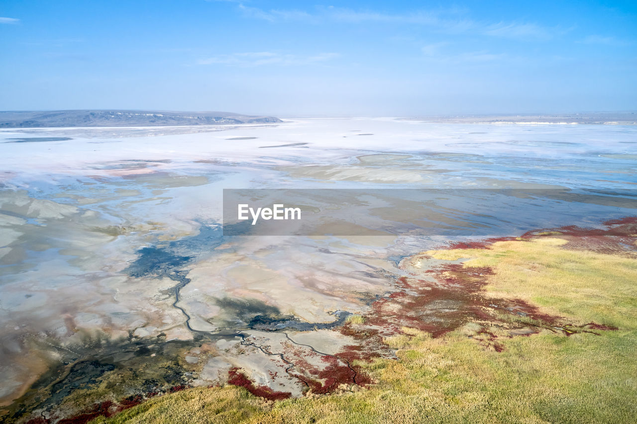 Amazing drone view from above of blue sea water washing rocky shore with mineral formations