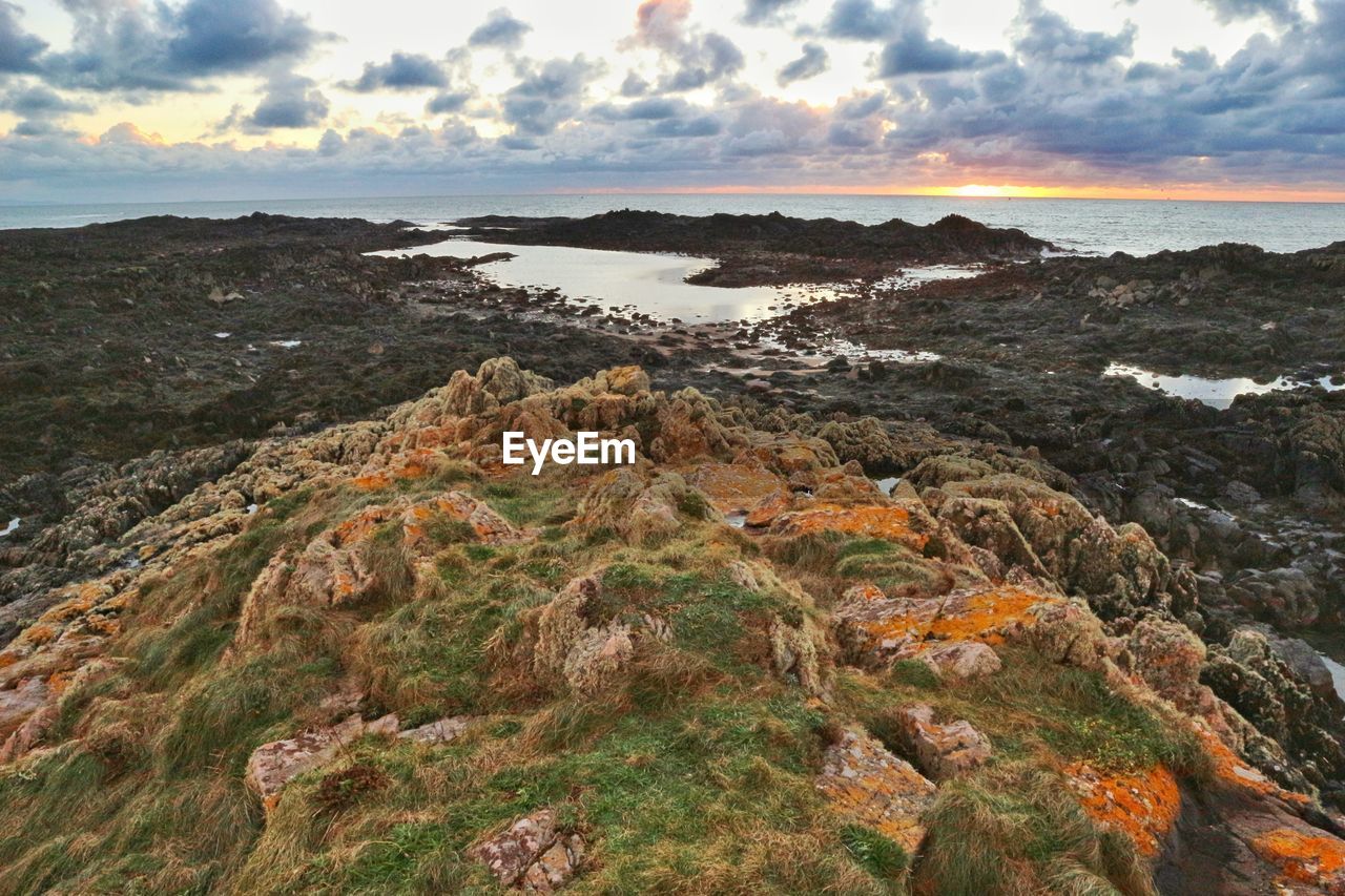 Scenic view of sea against sky at sunset