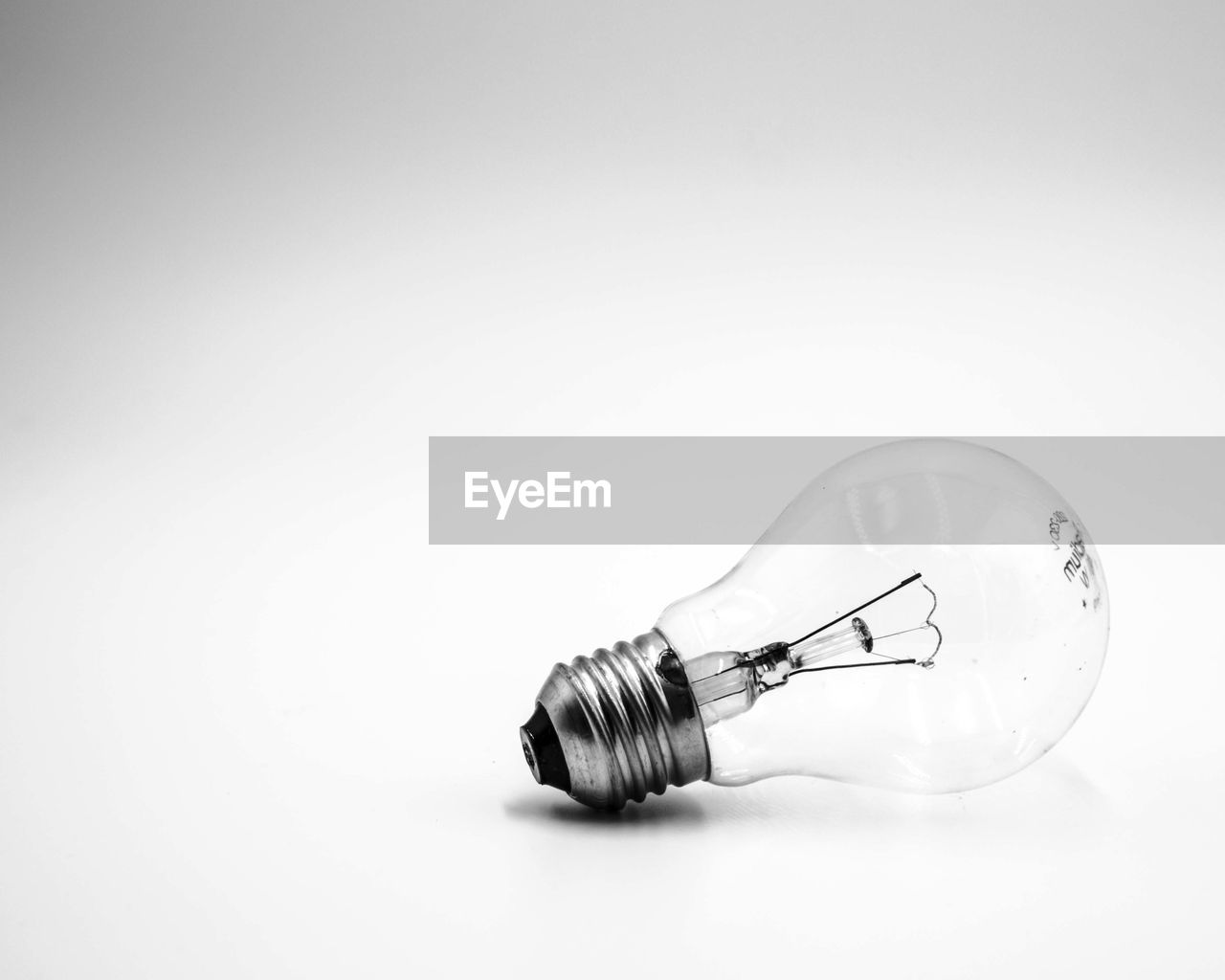 Close-up of light bulb over white background