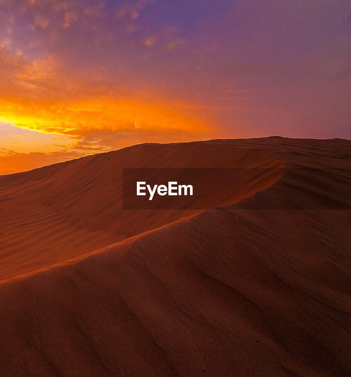 Scenic view of desert against sky during sunset