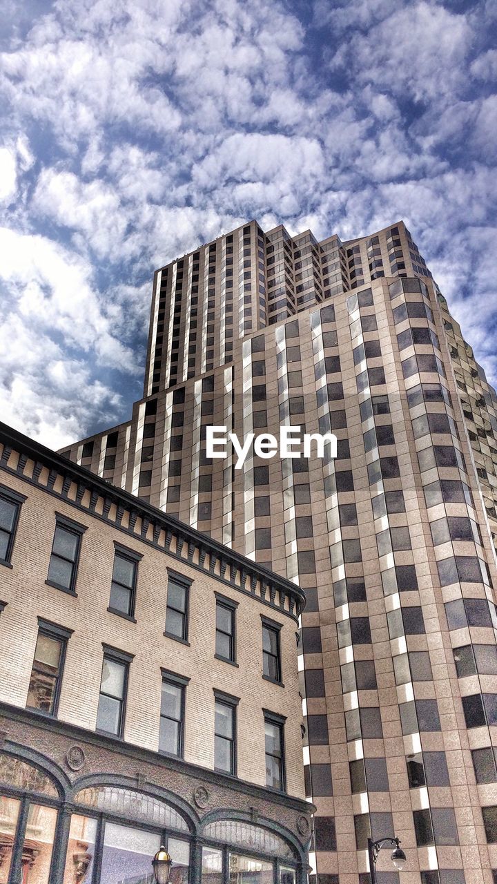 Low angle view of building against cloudy sky