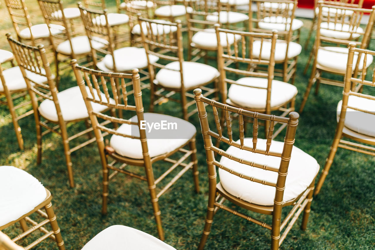 Gold chiavari chairs at outdoor garden wedding