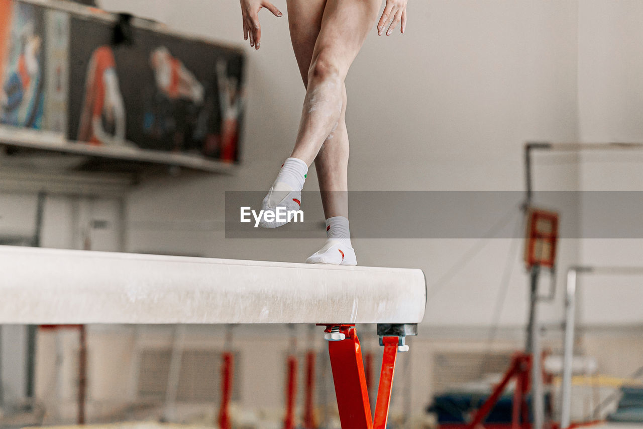 Low section of woman walking on sports equipment