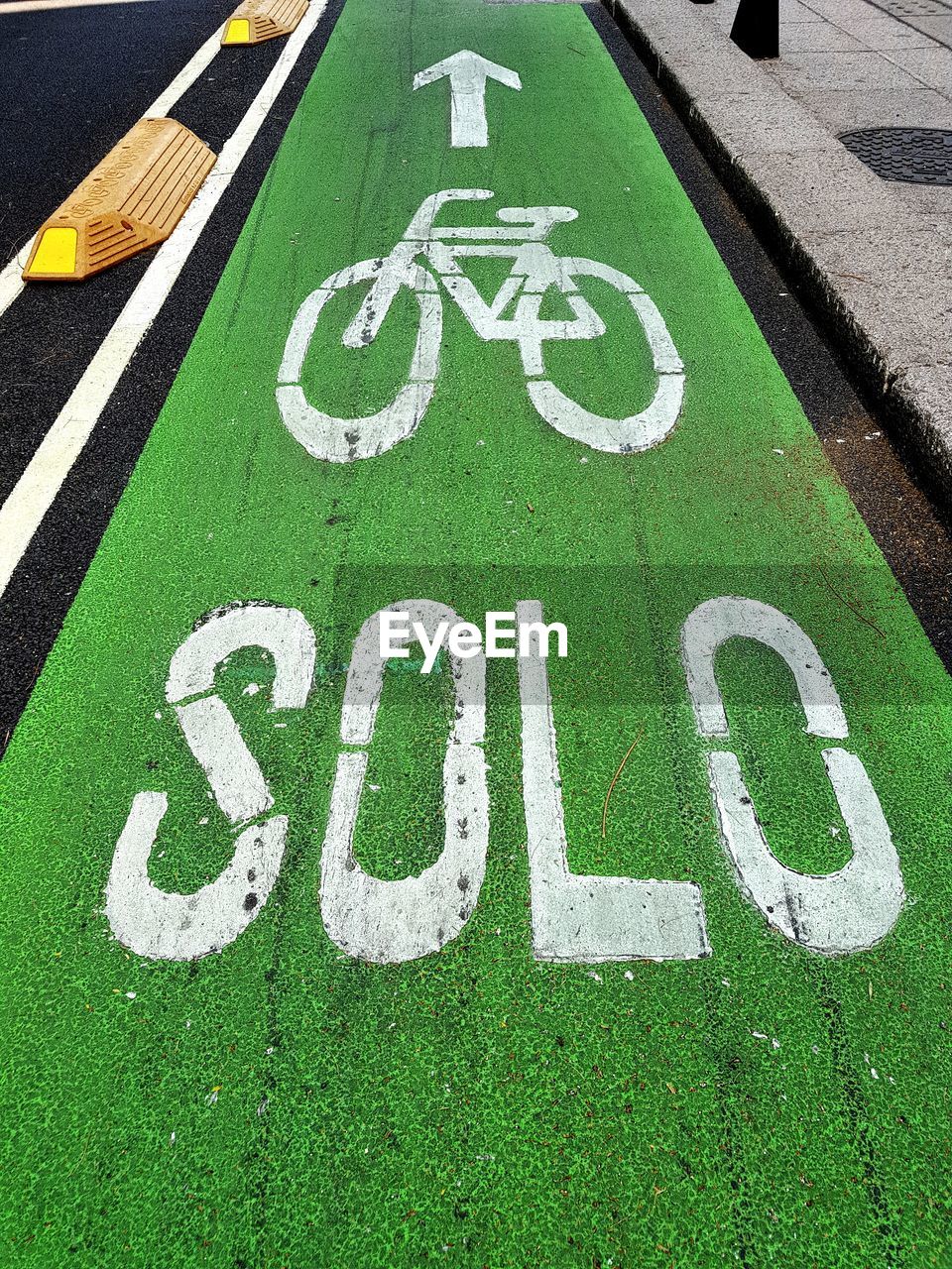 Bicycle lane sign and text on road