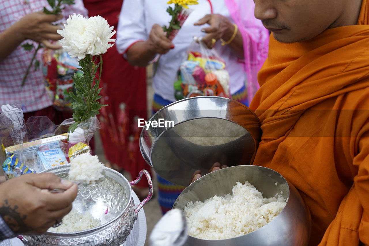 Midsection of people holding food