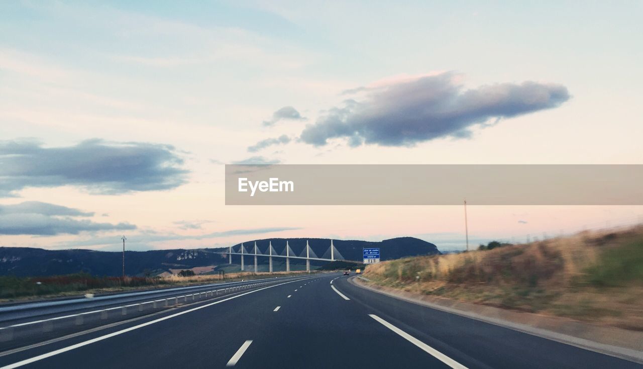 Road against millau bridge during sunset